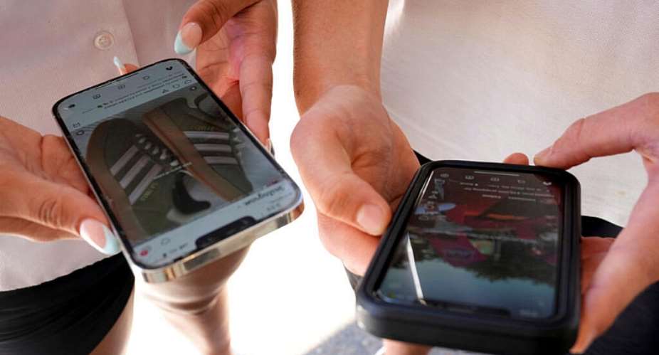 Young people use their phones to view social media in Sydney on November 8, 2024. -  Rick Rycroft, AP