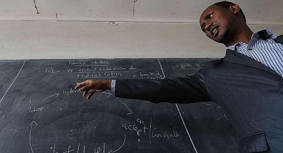 Kenyan teacher Ayub Mohamed giving a lesson in the Nairobi suburb of Eastleigh.  - Source: Tony KarumbaAFP via Getty Images