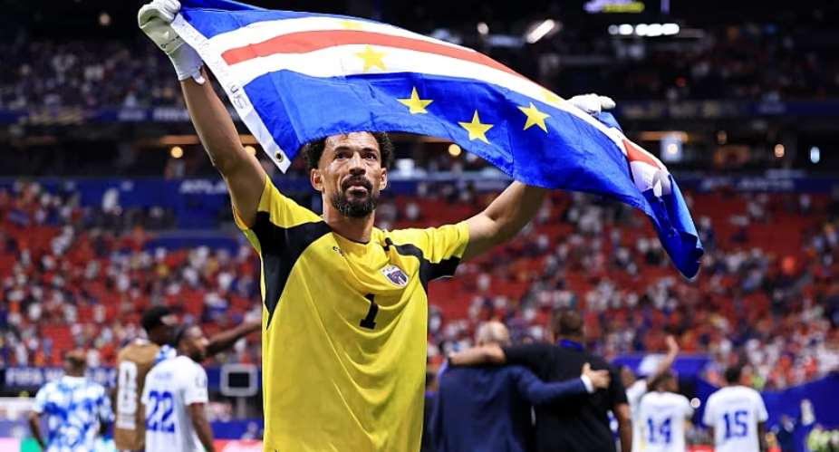 Cape Verde goalkeeper Vozinha holds up the nations flag after the 0-0 draw with Spain on Monday. Buda Mendes/Getty Images