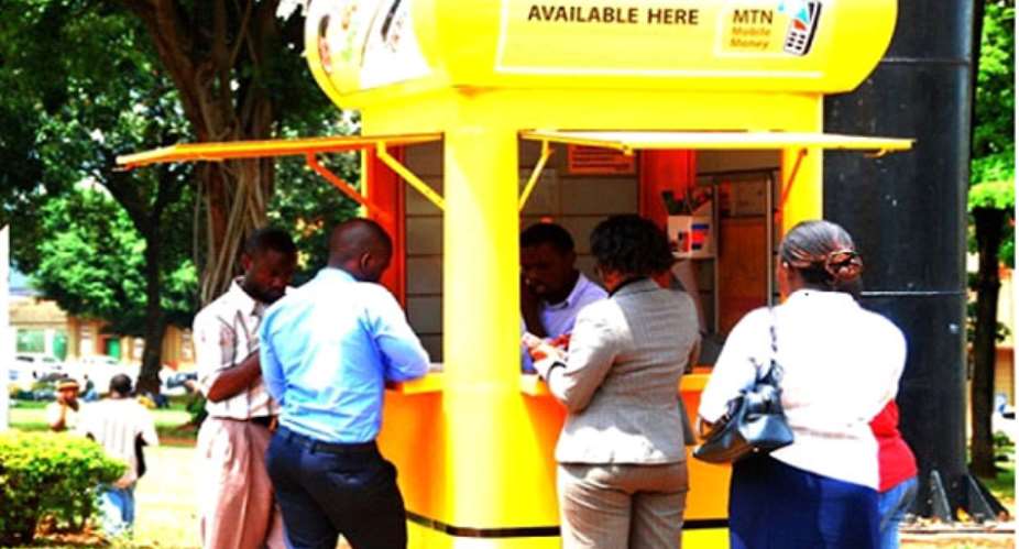 Some mobile money subscribers queue outside a kiosk