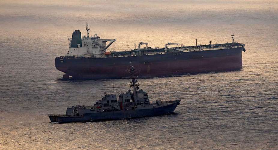 This US Navy handout photo released on May 8, 2026 by US Central Command Public Affairs shows the Arleigh Burke-class guided-missile destroyer USS Rafael Peralta (DDG 115) implementing a maritime blockade against the Iran-flagged crude oil tanker vessel Herby as it was attempting to sail toward an Iranian port, April 24, 2026. -  AFP