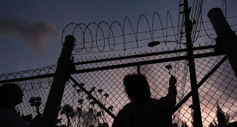 This file photo shows people placing flowers on a fence outside Krome Detention Center in Miami on May 24, 2025, during a vigil to recognise people who died in US Immigration and Customs Enforcement custody as well as those affected by mass deportations. -  Rebecca Blackwell, AP