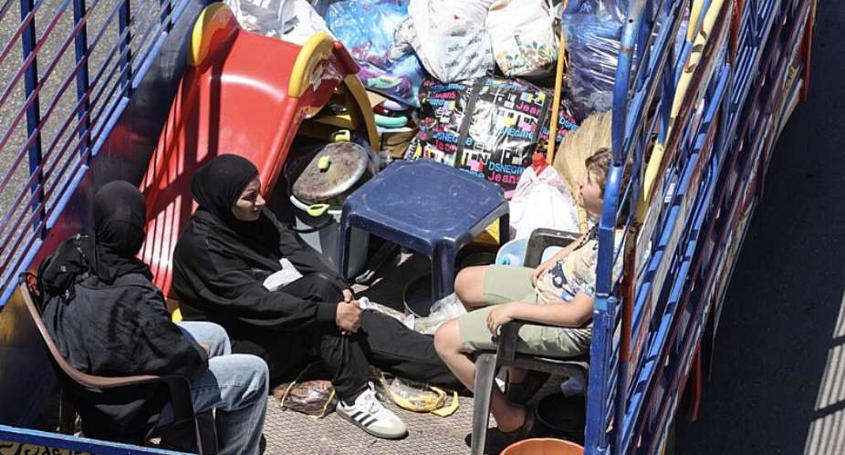 Residents of southern Lebanon fleeing Israeli airstrikes at the entrance to Saida with their belongings on June 19, 2026 -  Mahmoud Zayyat, AFP