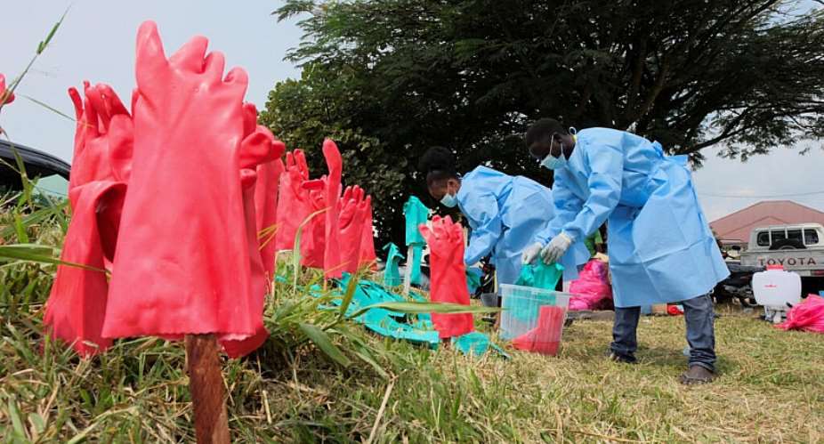 Medical workers in protective equipment wash their hands at an Ebola treatment centre at the Rwambara General Reference Hospital in Bunia, eastern DRC, 16 June 2026. -  REUTERS - Gradel Muyisa Mumbere