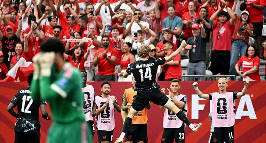 Canadas Jacob Shaffelburg celebrates with teammates their fifth goal, an own goal scored by Qatars Mohamed Manai as Qatars Mahmoud Abunada looks dejected. -  Simon Fearn, Reuters