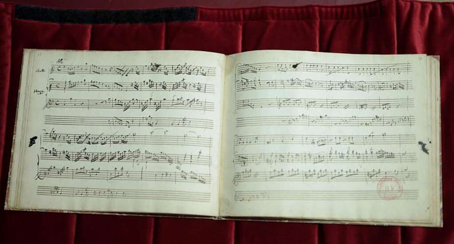 A composition notebook by Wolfgang Amadeus Mozart containing seven pieces for harp and flute is displayed at the National Library of France (BnF) in Paris on June 15, 2026. -  Kenzo Tribouillard, AFP