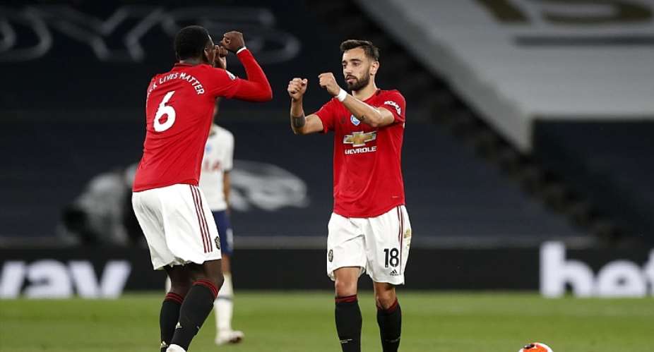 Bruno Fernandes of Manchester United celebrates after scoring his sides first goal with teammate Paul Pogba of Manchester United during the Premier League match between Tottenham Hotspur and Manchester United at Tottenham Hotspur Stadium on June 19, 2020Image credit: Getty Images