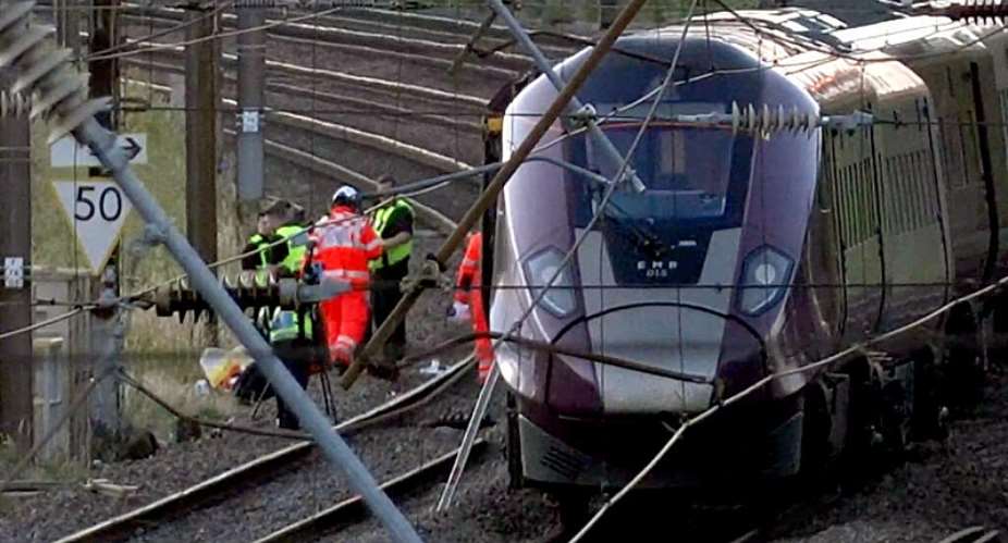 Emergency personnel work on a train on the tracks outside Bedford, England, after a train from Corby to London St. Pancras and another from Nottingham to London St. Pancras, collided on Friday June 19, 2026. -  Jamie Lashmar/PA via AP