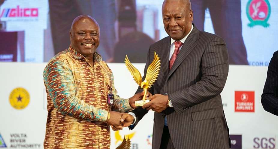 Hon. Joseph Cudjoe receiving award from H.E. John Mahama