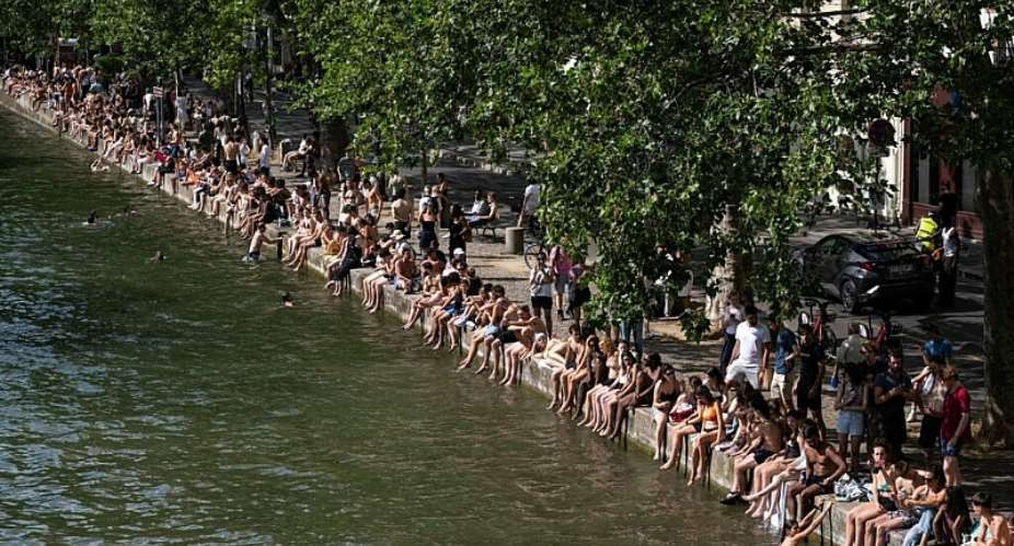 As temperatures soar across France, people have taken to swimming in rivers, lakes or canals, like here in the Canal Saint-Martin, in eastern Paris. Authorities warn not to swim in unauthorised areas. -  Arnaud Finistre/AFP