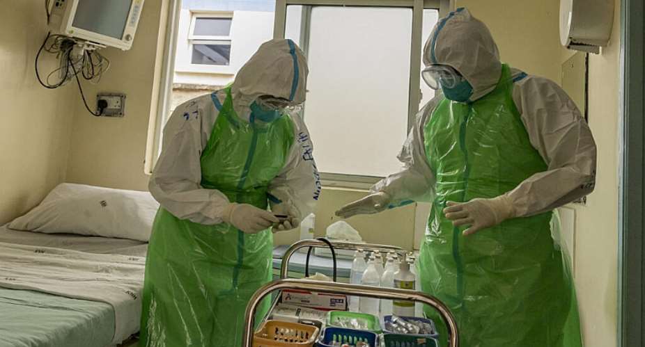 Two nurses in their Personal Protection Equipment (PPE) prepare to receive a patient with a highly infectious disease such as Ebola, during a simulation exercise at the special isolation ward of the department of Infectious Diseases Unit (IDU) at the the Kenyatta National hospital in Nairobi on 12 June, 2026. - AFP - SIMON MAINA