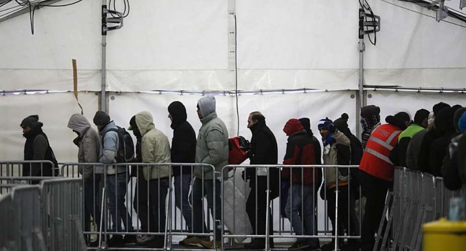 Migrants line up at a registration centre for asylum seekers in Berlin, Germany. - AP - Markus Schreiber