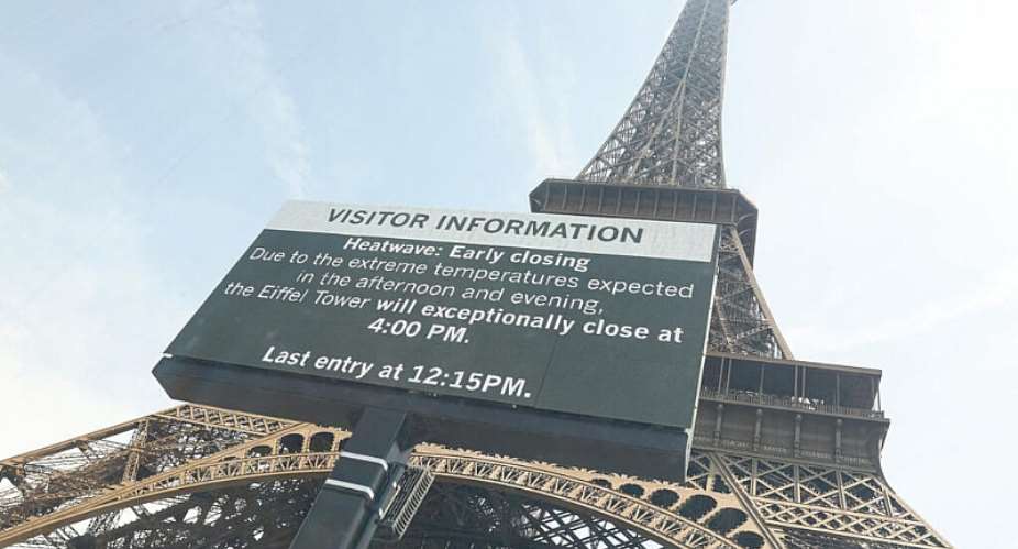This photograph shows the Eiffel Tower with a giant screen announcing its early closure due to a heatwave in Paris on June 23, 2026. -  Charlotte Siemon, AFP