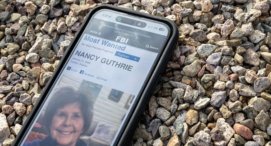 A photo of Nancy Guthrie, mother of the American journalist Savannah Guthrie, on a smartphone, taken February 10, 2026. -  Brandon Bell, AFP
