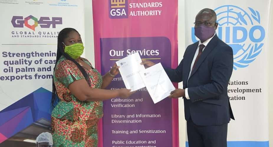 Abena Safoa Osei, Chief Technical Advisor  National Coordinator Global Quality and Standards Programme – Ghana with Prof. Alex Dodoo, GSA Director-General, displaying copies of the standards