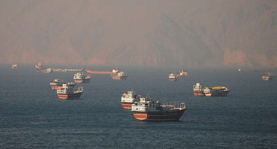Vessels transit the Strait of Hormuz, seen from Musandam, Oman, on 15 June, as maritime authorities warn of suspected mines in the area. - REUTERS - Stringer