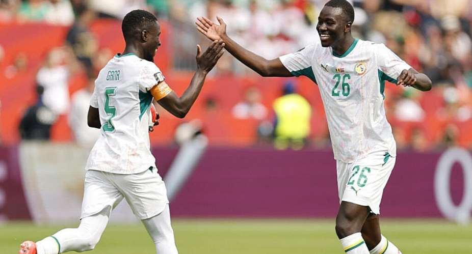 Pape Guey celebrates with teammate Idrissa Gana Gueye after scoring Senegals fourth goal. - Getty Images via AFP - MICHAEL REAVES