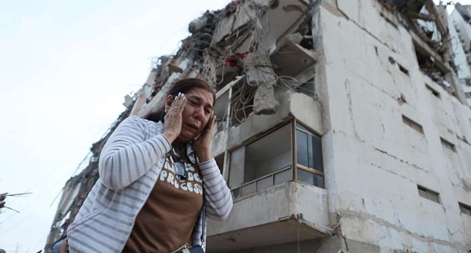 A woman walks past a building damaged during an earthquake in La Guaira, Venezuela on June 25, 2026. -  Pedro Mattey, AP