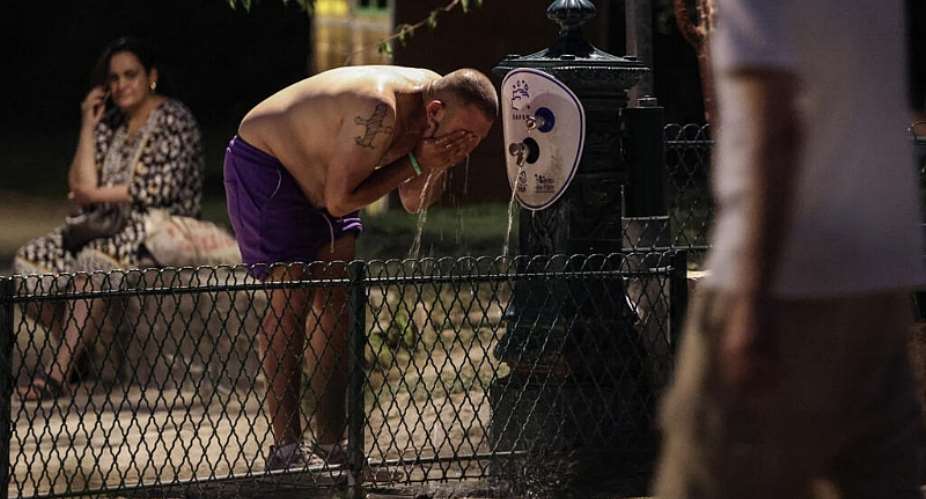 A man cools off at a public fountain near the Canal Saint-Martin in Paris during a heatwave, June 25, 2026. -  Ludovic Marin, AFP