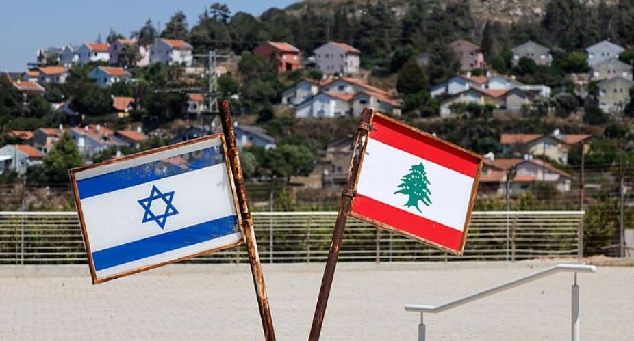 Representations of the Israeli and Lebanese flags at a memorial near the Israel-Lebanon border, after Israel and Lebanon signed a framework agreement following U.S.-mediated talks, as the town of Metula, Israel, appears in the distance, June 27, 2026. -  Amir Cohen, Reuters