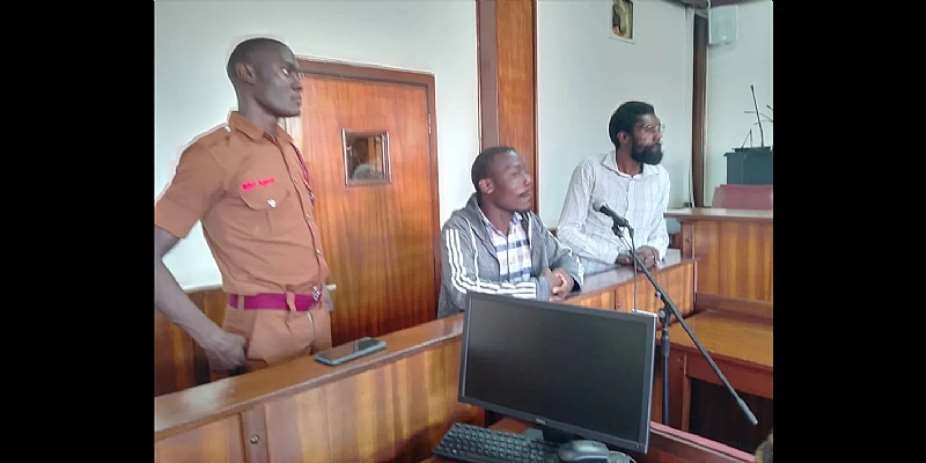 Dickson Mubiru (right), managing editor of theGrapeVine, and Alirabaki Sengooba (center), a reporter for the outlet, appear in court on June 20, 2024. They have been charged with two counts of “publishing information without a valid broadcasting license” and were remanded to prison. (Photo: Trusted News Uganda)