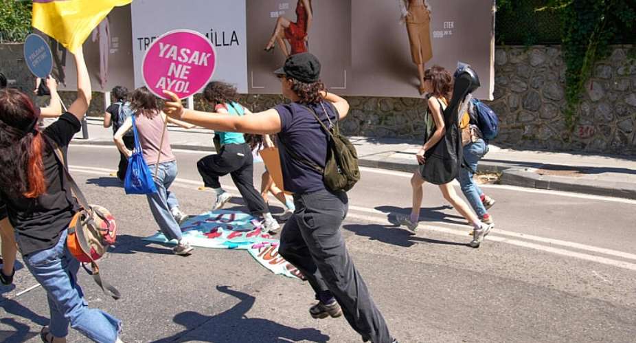 People run from the police during a march in support of transgender people and their rights during the LGBTQ Pride week, in Istanbul, Turkey, Sunday, June 21, 2026. The placard reads in colloquial Turkish: Whats forbidden. Come on!. -  Dilara Acikgoz, AP