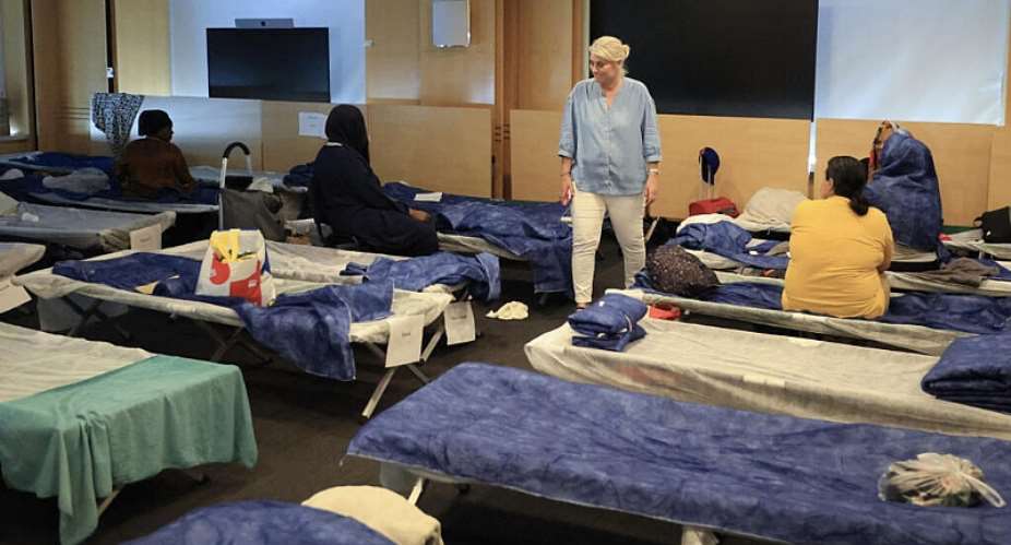 Frances Health Minister Stephanie Rist walks amid camp bed as she visits an emergency shelter during the heatwave in Paris on June 26, 2026. -  Ludovic Marin, AFP