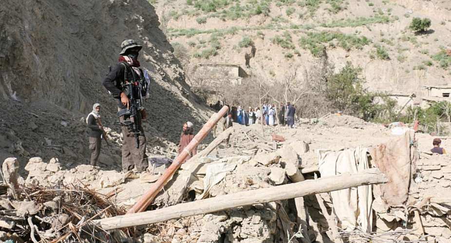 A Taliban security member stands on top of the debris of a house following an airstrike that the Taliban said was carried out by Pakistan on June 10, 2026. -  Reuters