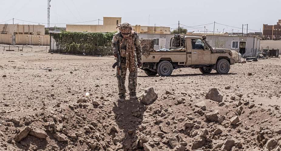 A soldier from the National Front for the Liberation of Azawad (FLA) inspects a crater in Kidal on May 14, 2026 caused by aerial bombardment from Malian Armed Forces (FAMA). -  AFP