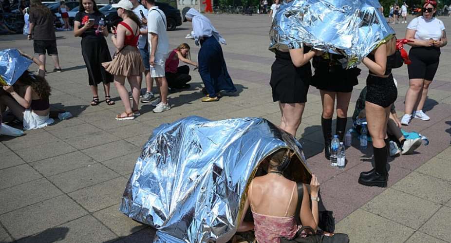 People used emergency blankets to protect themselves from the heat in Berlin on Sunday. -  Ralf Hirschberger, AFP