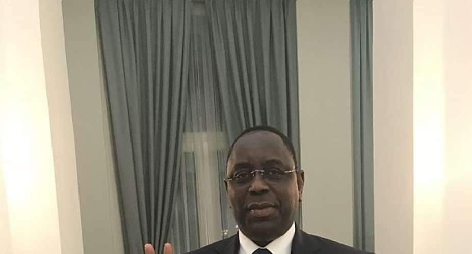 President Macky Sall poses with StateCraft Inc. flagship book, How to Win Elections in Africa