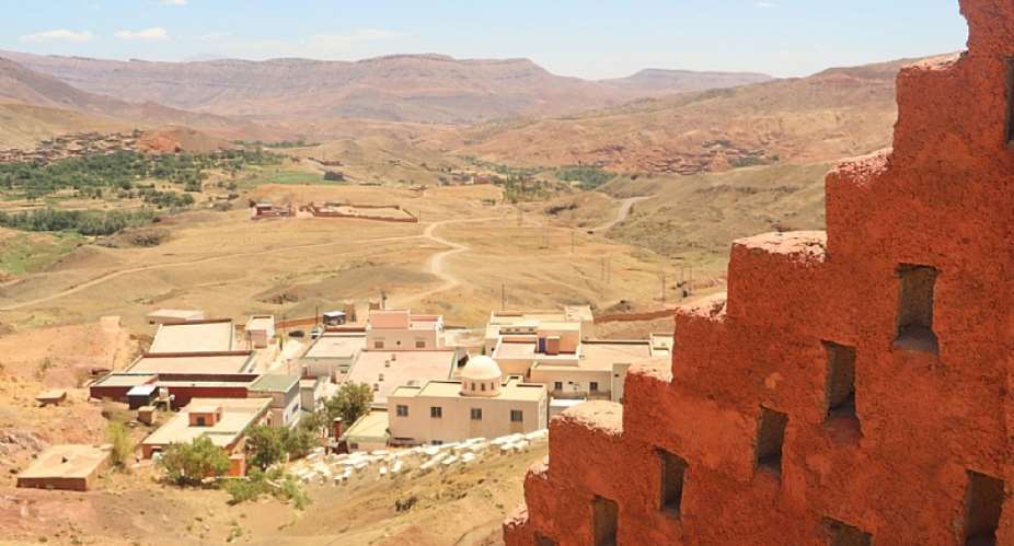 The burial place of the venerated Rabbi David-ou-Moshe as seen from the entryway to the adjacent hilltop fruit tree nursery. Imerdal, Morocco. July 2021. Photo: Katie BercegeayHigh Atlas Foundation