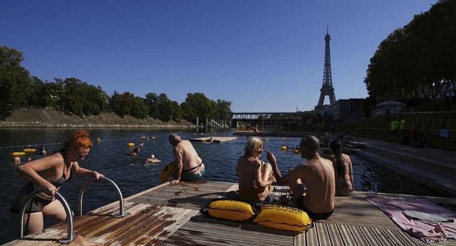 People enjoy the sun after a swim in the Seine river,  August 11, 2025 in Paris. -  Aurelien Morissard, AP