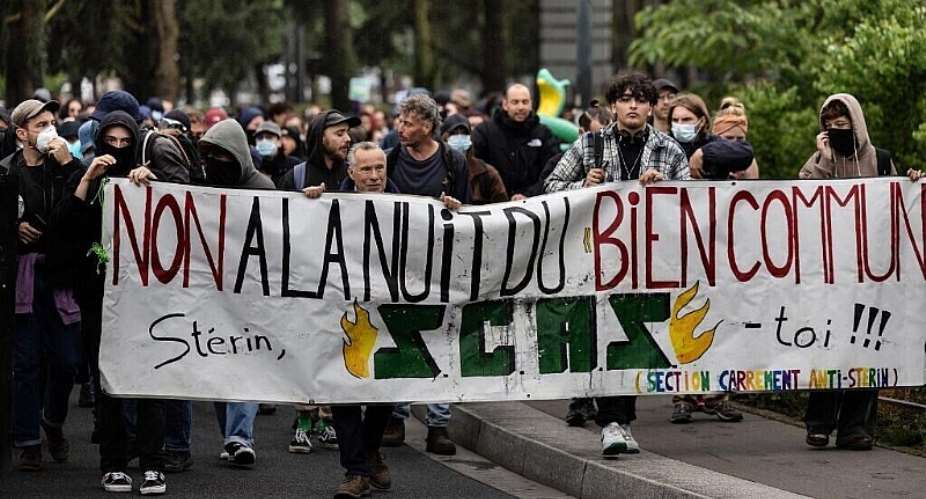 Protestors hold a banner reading No to La Nuit du Bien Commun (Night of Common Good), Sterin get out as they demonstrate against a gala for a movement co-founded by Pierre-Edouard Sterin, in Nantes, western France, on June 5, 2025. - AFP - FRED TANNEAU