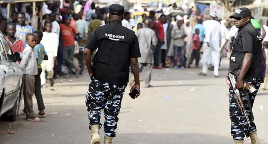 Federal Special Anti-Robbery Squad officers are seen in Kano, Nigeria, on February 23, 2019. Journalist Kofi Bartels told CPJ he was recently assaulted and threatened by anti-robbery officers. AFPPius Utomi Ekpei