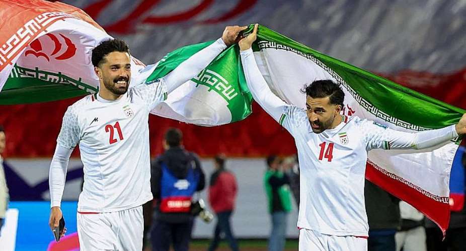 AFP via Getty Images: Iran players Omid Norafkan and Saman Ghoddos celebrate after a qualifying match in 2025