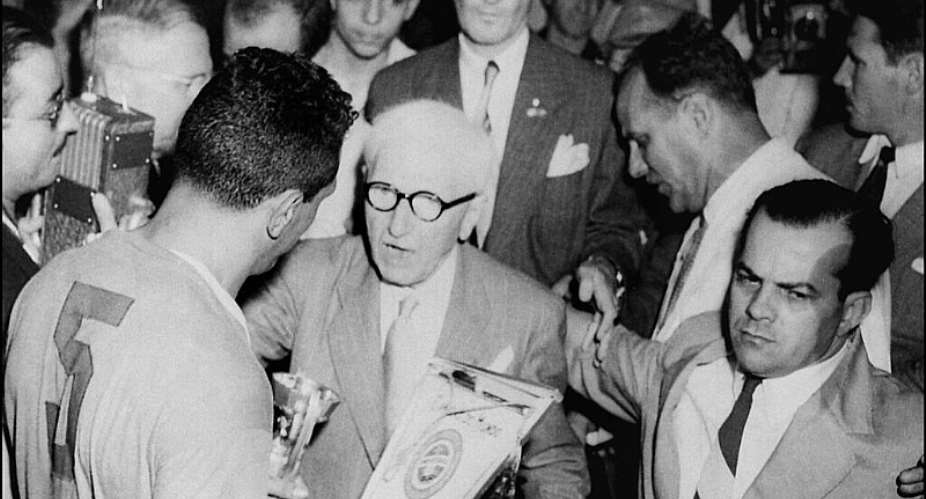 Jules Rimet(centre) hands over the trophy bearing his name to the Uruguay captain Obdulio Varela after his sides 2-1 win in the final match of the 1950 World Cup in Brazil. - AFP