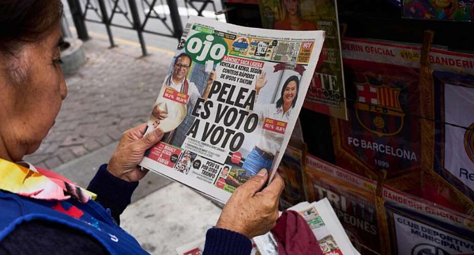 A newspaper vendor reads the front page of a newspaper that reads in Spanish: The fight is vote by vote in Lima, Peru, Monday, June 8, 2026, a day after the presidential election runoff. -  Rodrigo Abd, AP
