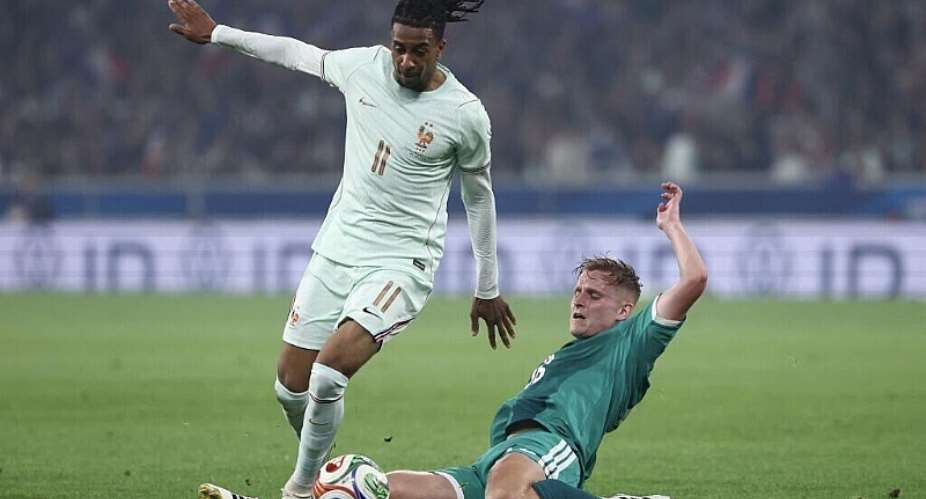 Frances forward #11 Michael Olise (L) and Northern Irelands midfielder #16 Alistair McCann fight for the ball during the international friendly football match between France and North Ireland at the Decathlon Arena - Pierre Mauroy stadium in Villeneuve-dAscq, northern France ahead of the 2026 FIFA World Cup football tournament, on 8 June 2026. - AFP - FRANCK FIFE
