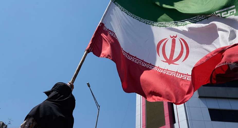 A woman holds an Iranian flag during a pro-government campaign in downtown Tehran on June 8, 2026. -  Vahid Salemi, AP