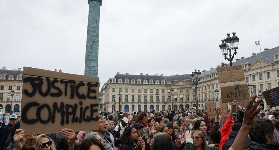 Placard reads: The Justice system is complicit seen at an unauthorised demonstration outside the French Justice Ministry in Paris on 8 June, 2026. It was organised by MouvEnfants and other organisations to demand a law against violence on minors, following the death of 11 year-old Lyhanna. - AFP - GEOFFROY VAN DER HASSELT