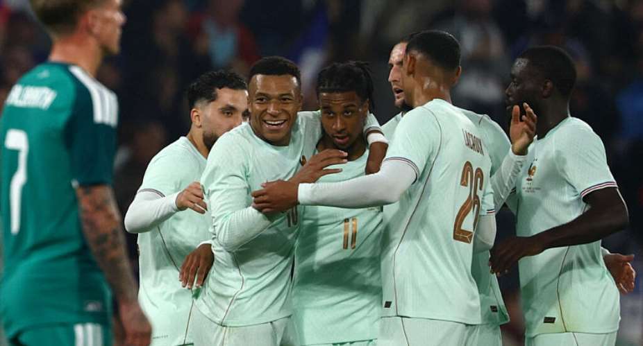 Frances Michael Olise (centre) celebrates with Kylian Mbapp and teammates after scoring his third goal against Ireland. -  Sarah Meyssonnier, Reuters