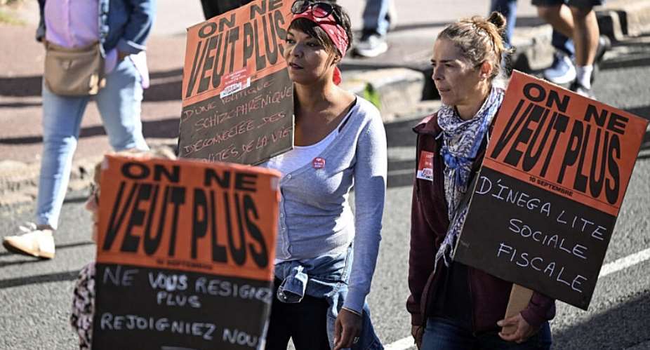 Protestors hold banners reading We no longer want social and fiscal inequality” at a demonstration in Bayonne, southern France, 2 October 2025. - AFP - GAIZKA IROZ