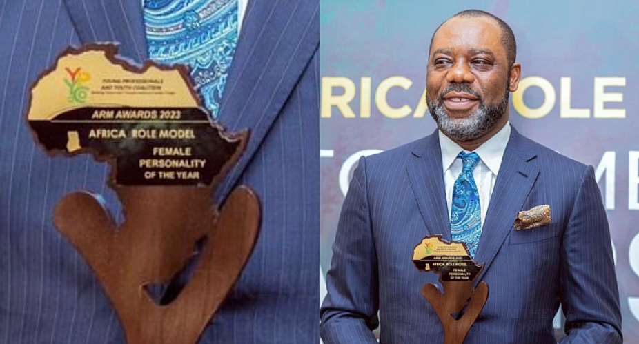 Energy Minister, Matthew Opoku Prempeh, with the mistaken female award plaque