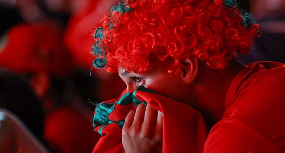 A Morocco fan at the Prince Moulay Abdellah Stadium in Rabat watches in despair as his team loses the quarter-final against France. - AFP - ABDEL MAJID BZIOUAT