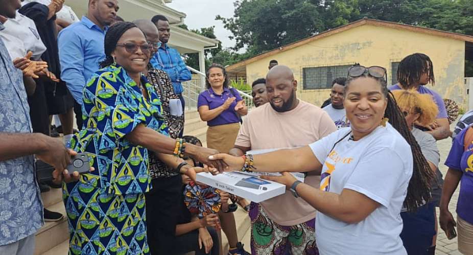 The Headmistress of Accra High, Madam Evelyn Sagbil Nabia, receiving the donations from the QEA reps