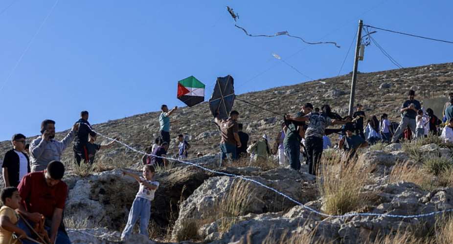Palestinians from the Israeli-occupied West Bank village of Burin celebrate the annual kite festival, which they say offers some respite from the daily hardship. -  Jaafar Ashitiyh, AFP