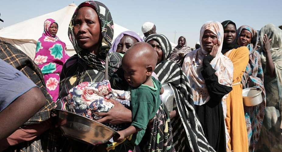 Women displaced from El Fasher queue for food aid at Al-Afadh camp in Al Dabbah, northern Sudan, in November 2025, after fleeing fighting in North Darfur. - AP - Marwan Ali