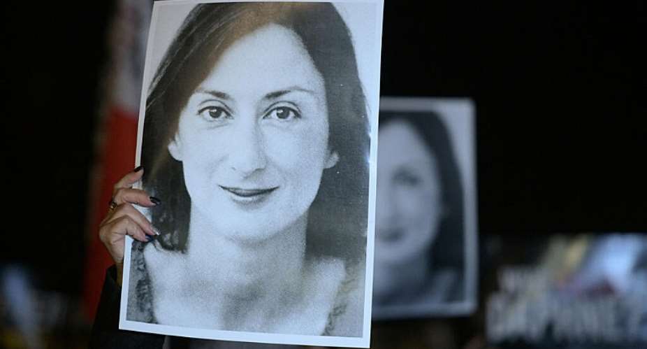 Protesters hold pictures of the late journalist Daphne Caruana Galizia in Valletta, Malta on November 20, 2019. -  Matthew Mirabelli, AFP
