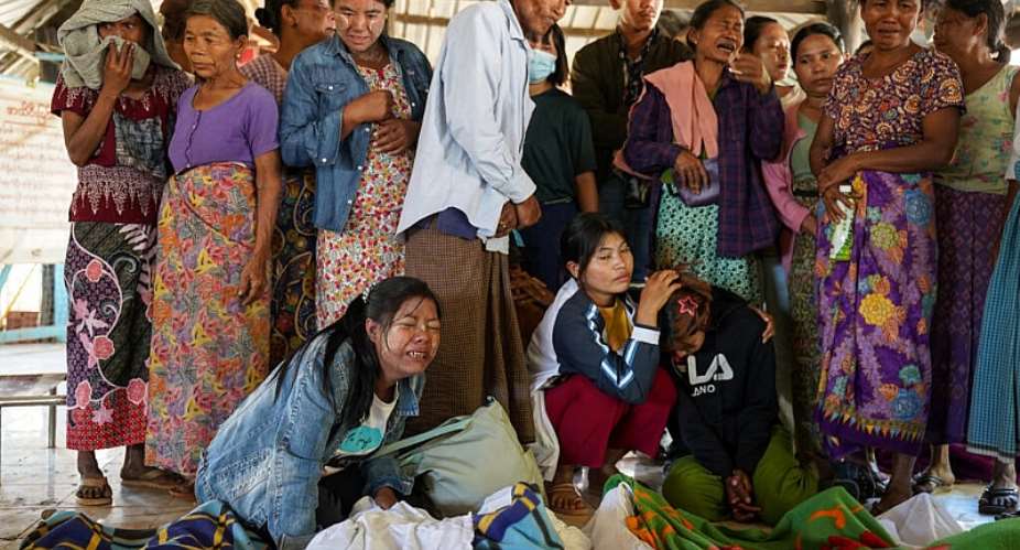 Mourners grieve as bodies are laid out at a cemetery after a Myanmar military strike at a hospital killed more than 30 people in western Rakhine state on December 11, 2025. -  AFP file photo